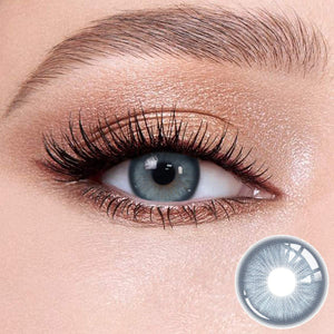 Baroque Blue contact lenses on the eyes, close-up of the product on the lower right