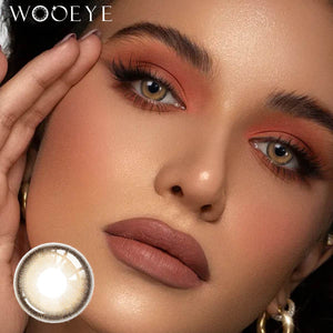 The girl's face is looking straight ahead, the upper left is the Wooeye logo, and the lower left is a close-up of the Hazel Brown contact lens