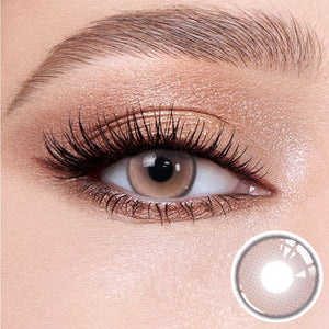 The effect of wearing Aura Purple Contact Lenses, with a close-up of the product in the lower right corner