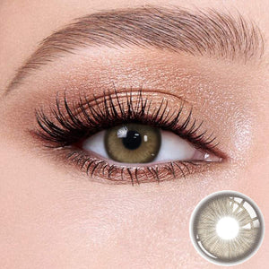 Baroque Brown contact lenses on the eyes, close-up of the product on the lower right