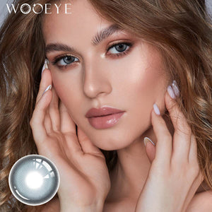 The girl's face is looking straight ahead, the upper left is the Wooeye logo, and the lower left is a close-up of the Milk Galaxy Blue contact lens