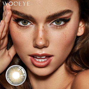 The girl's face is looking straight ahead, the upper left is the Wooeye logo, and the lower left is a close-up of the Dancer Deep Grey contact lens