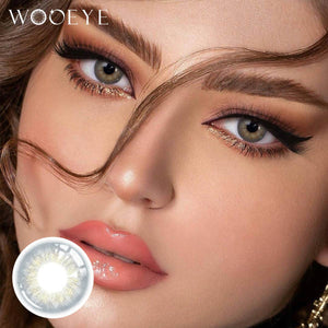 The girl's face is looking straight ahead, the upper left is the Wooeye logo, and the lower left is a close-up of the taylor gray contact lens