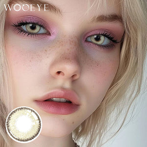 The girl's face is looking straight ahead, the upper left is the Wooeye logo, and the lower left is a close-up of the Flaxseed Gray contact lens