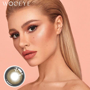 The girl's face is looking straight ahead, the upper left is the Wooeye logo, and the lower left is a close-up of the Acorn Black Grey contact lens