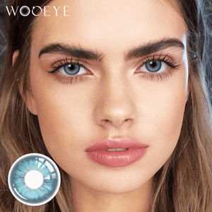 The girl's face is looking straight ahead, the upper left is the Wooeye logo, and the lower left is a close-up of the Amber Blue contact lens
