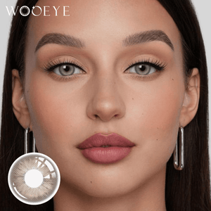 The girl's face is looking straight ahead, the upper left is the Wooeye logo, and the lower left is a close-up of the AmberBrown contact lens