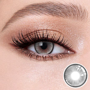 The effect of wearing Boston Grey Contact Lenses, with a close-up of the product in the lower right corner