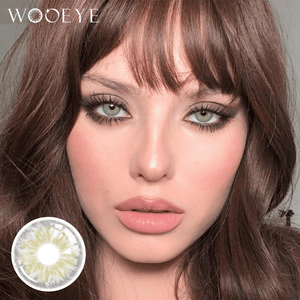 The girl's face is looking straight ahead, the upper left is the Wooeye logo, and the lower left is a close-up of the Cleo Gray contact lens