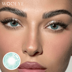 The girl's face is looking straight ahead, the upper left is the Wooeye logo, and the lower left is a close-up of the Cosmos Green contact lens