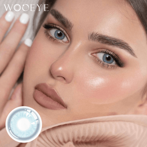 The girl's face is looking straight ahead, the upper left is the Wooeye logo, and the lower left is a close-up of the Glacier Blue contact lens