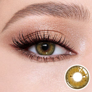 The effect of wearing Magic Brown Contact Lenses, with a close-up of the product in the lower right corner