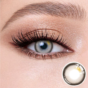 The effect of wearing Misty Gray Contact Lenses, with a close-up of the product in the lower right corner