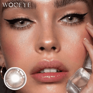 The girl's face is looking straight ahead, the upper left is the Wooeye logo, and the lower left is a close-up of the Snowfall Brown contact lens