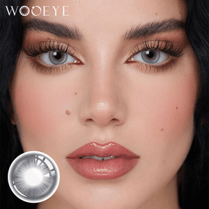 The girl's face is looking straight ahead, the upper left is the Wooeye logo, and the lower left is a close-up of the Snowfall Gray Blue contact lens