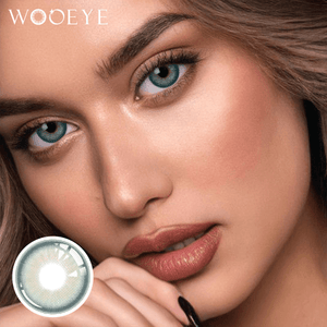 The girl's face is looking straight ahead, the upper left is the Wooeye logo, and the lower left is a close-up of the Star Green contact lens