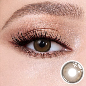 The effect of wearing Master Tea Brown Contact Lenses, with a close-up of the product in the lower right corner