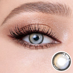 The effect of wearing Nightfall Seaside Blue Contact Lenses, with a close-up of the product in the lower right corner