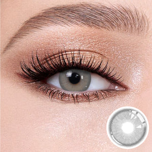 The effect of wearing Alice Grey Contact Lenses, with a close-up of the product in the lower right corner