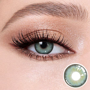 The effect of wearing Diamond Green II Contact Lenses, with a close-up of the product in the lower right corner