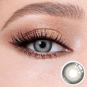 The effect of wearing Jennie Grey Contact Lenses, with a close-up of the product in the lower right corner