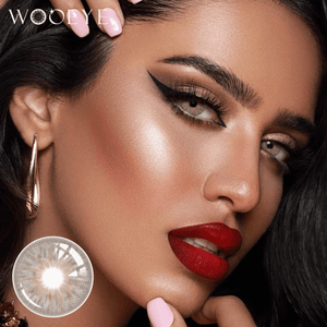 The girl's face is looking straight ahead, the upper left is the Wooeye logo, and the lower left is a close-up of the avatar brown contact lens