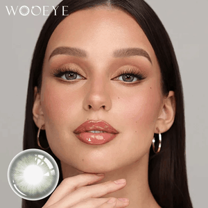 The girl's face is looking straight ahead, the upper left is the Wooeye logo, and the lower left is a close-up of the human barbie green contact lens