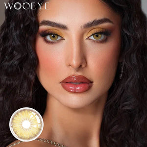 The girl's face is looking straight ahead, the upper left is the Wooeye logo, and the lower left is a close-up of the Breeze Hazel Brown contact lens