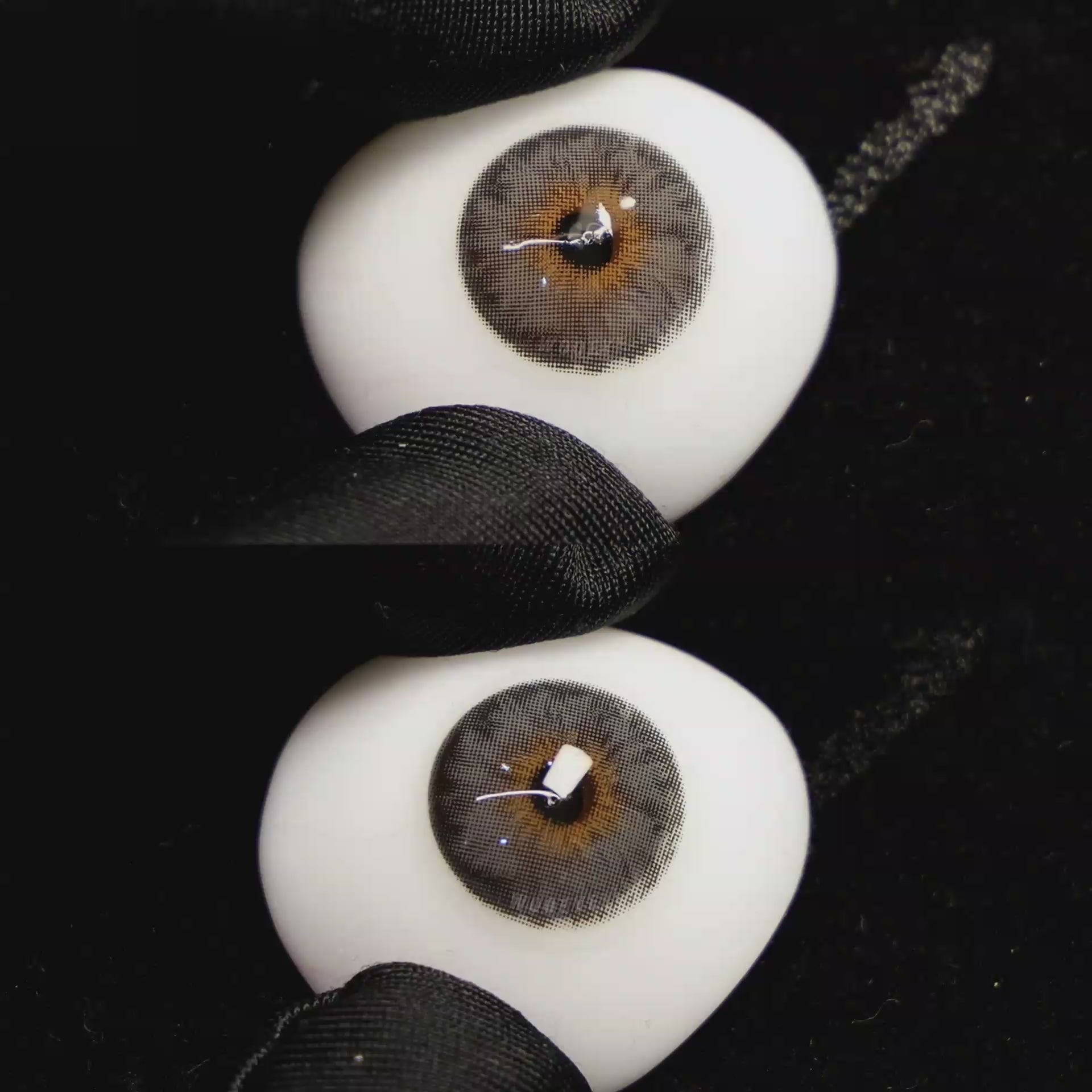 A simulated brown prosthetic eye showing the visual transformation effect of wearing Wooeye Mermaid Grey colored contact lenses against a black background.