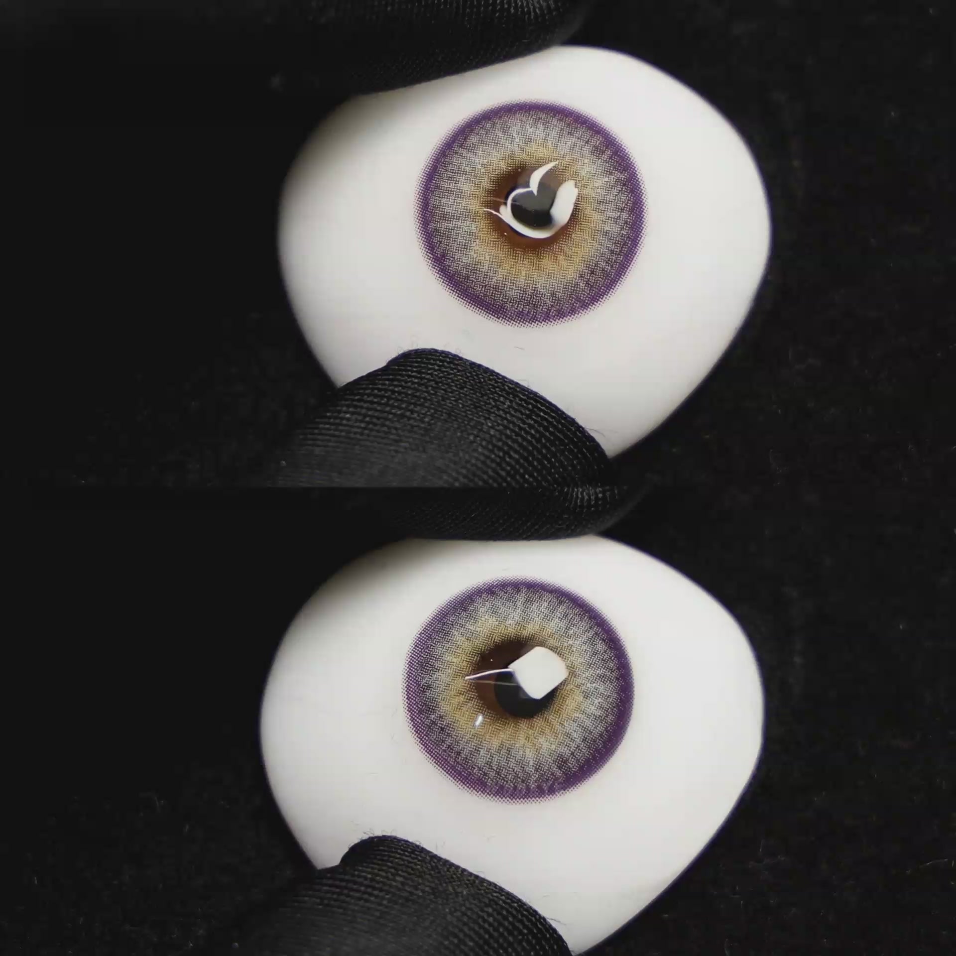 A simulated brown prosthetic eye showing the visual transformation effect of wearing Wooeye Pola Purple colored contact lenses against a black background.