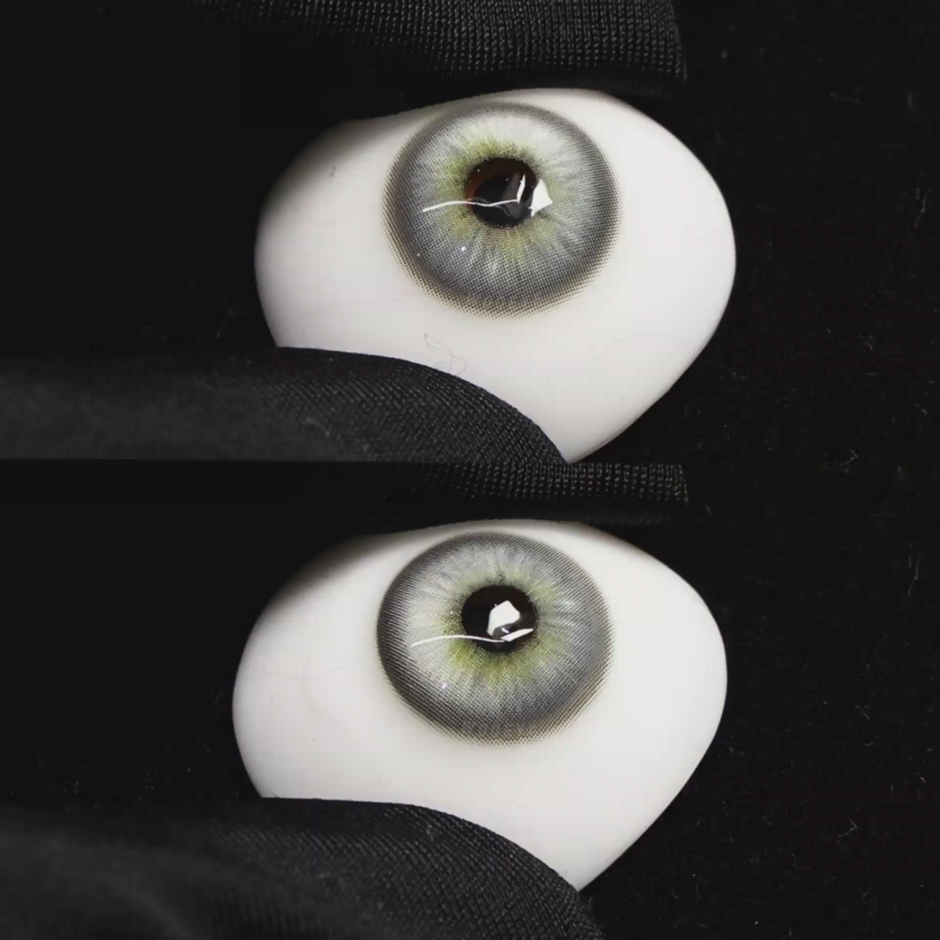 A simulated brown prosthetic eye showing the visual transformation effect of wearing Wooeye Casa Gray colored contact lenses against a black background.