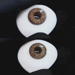 A simulated brown prosthetic eye showing the visual transformation effect of wearing Wooeye Omg Brown I colored contact lenses against a black background.