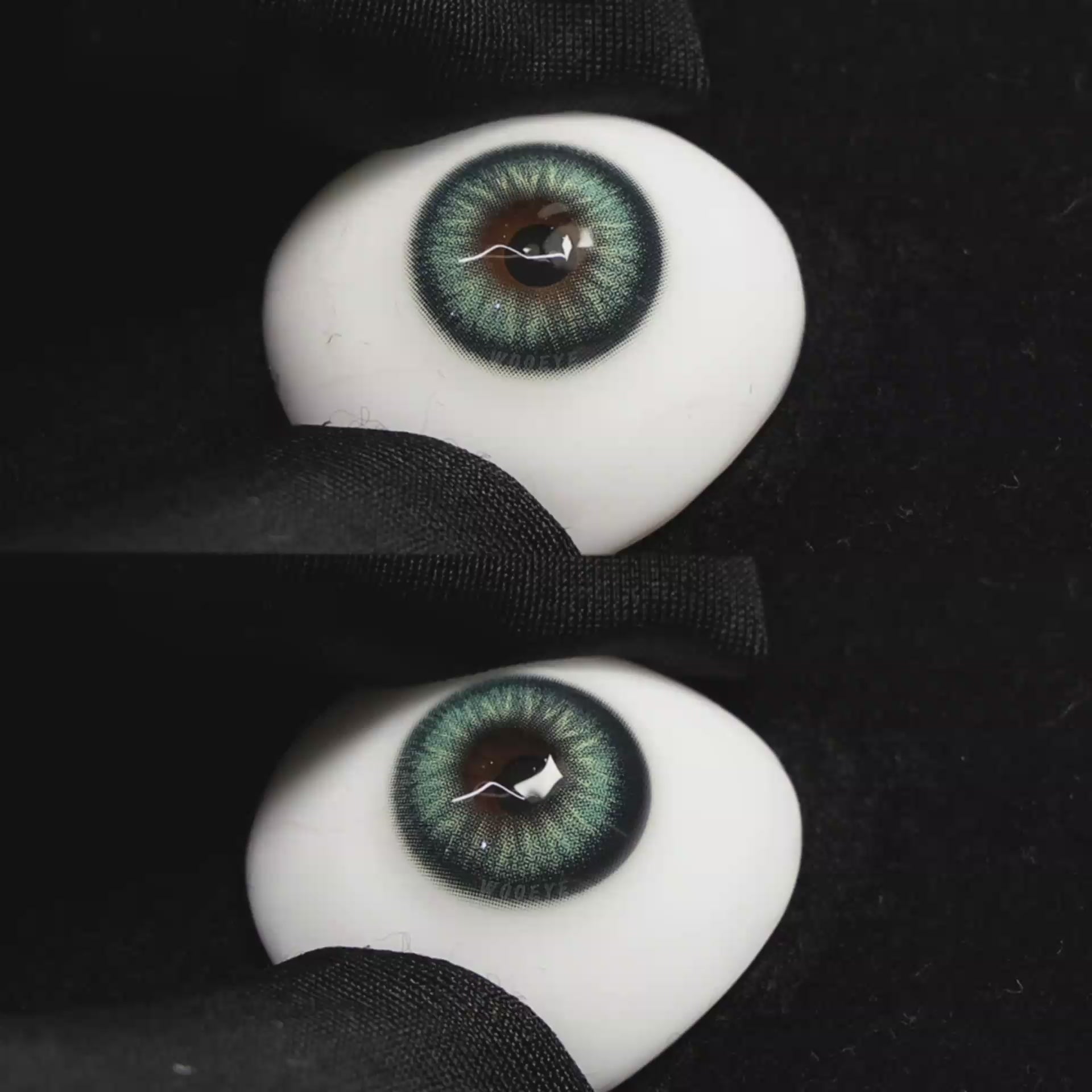 A simulated brown prosthetic eye showing the visual transformation effect of wearing Wooeye Nut Green colored contact lenses against a black background.