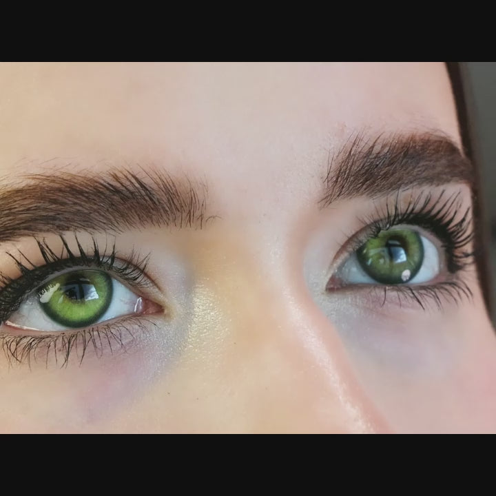 Woman winks while wearing Casa Green contact lenses