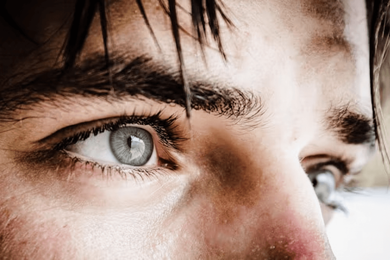 Close-up of a steel gray human eye showing natural beauty, clarity, and calm expression.
