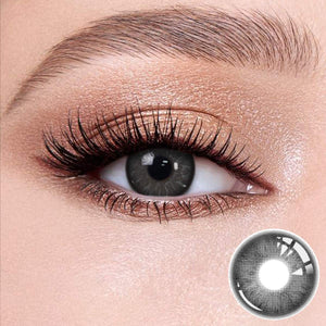 Pixel Black contact lenses on the eyes, close-up of the product on the lower right