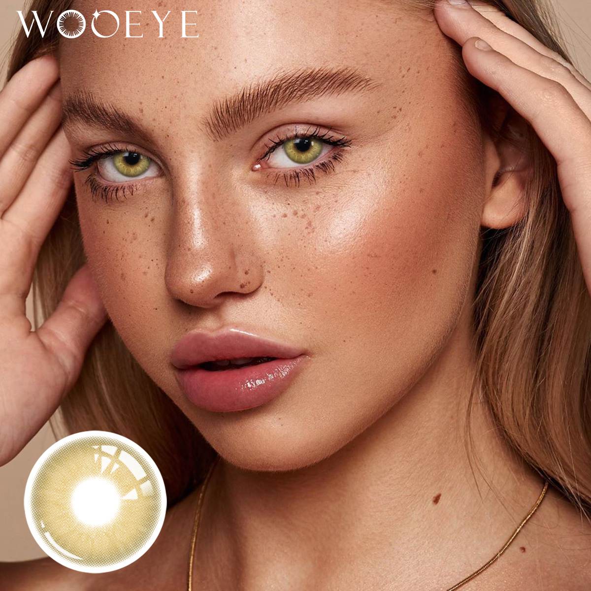 The girl's face is looking straight ahead, the upper left is the Wooeye logo, and the lower left is a close-up of the Moonlit Brown contact lens