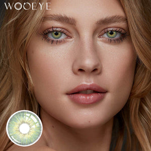 The girl's face is looking straight ahead, the upper left is the Wooeye logo, and the lower left is a close-up of the Mist Green contact lens