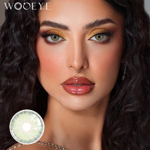 The girl's face is looking straight ahead, the upper left is the Wooeye logo, and the lower left is a close-up of the Breeze Grey contact lens