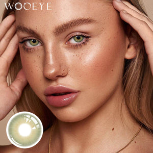 The girl's face is looking straight ahead, the upper left is the Wooeye logo, and the lower left is a close-up of the Moonlit Green contact lens
