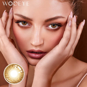 The girl's face is looking straight ahead, the upper left is the Wooeye logo, and the lower left is a close-up of the Sepia Brown contact lens