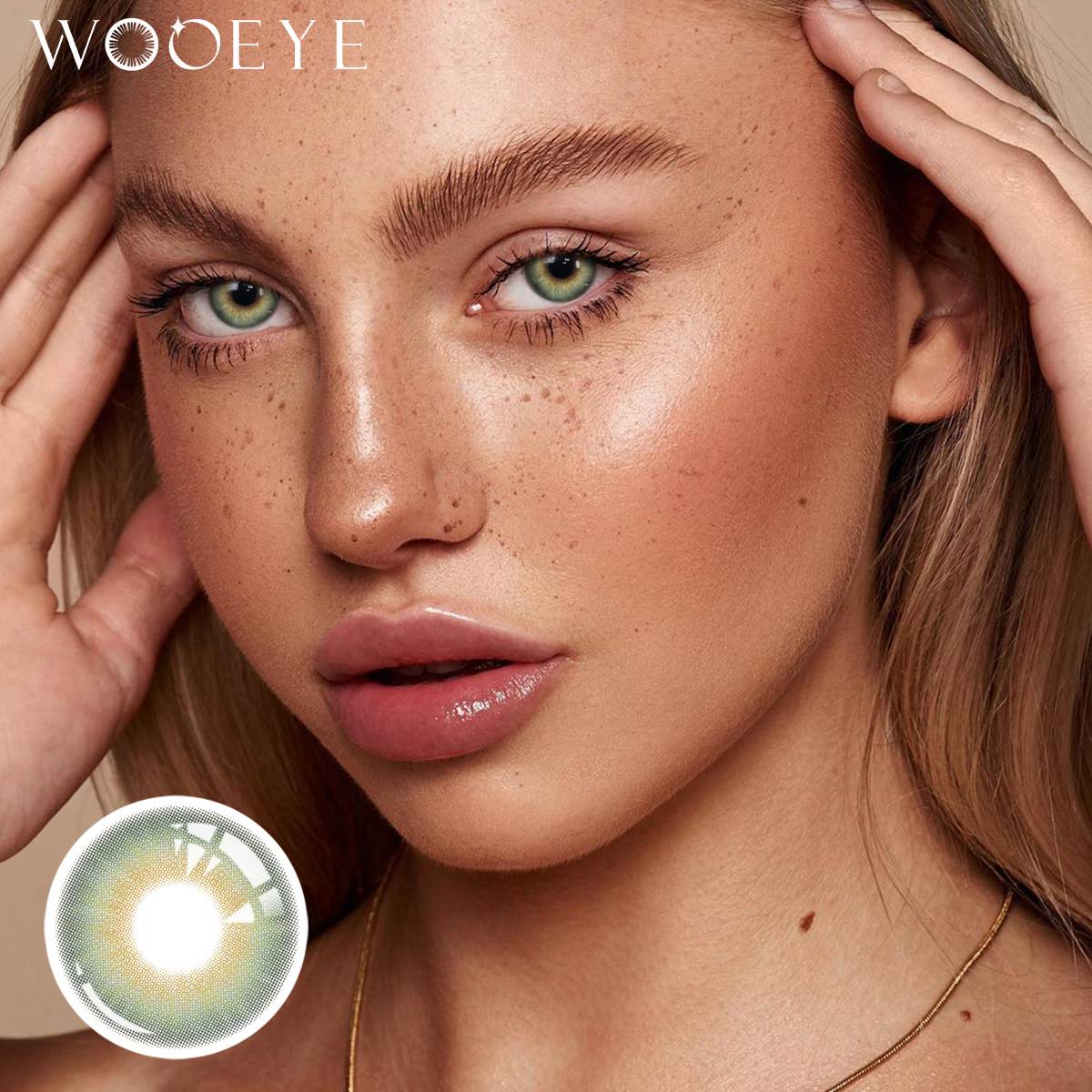 The girl's face is looking straight ahead, the upper left is the Wooeye logo, and the lower left is a close-up of the Moonlit Blue contact lens