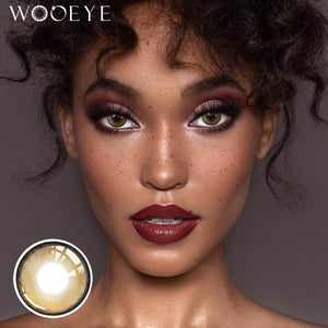 The girl's face is looking straight ahead, the upper left is the Wooeye logo, and the lower left is a close-up of the Milk Grey contact lens