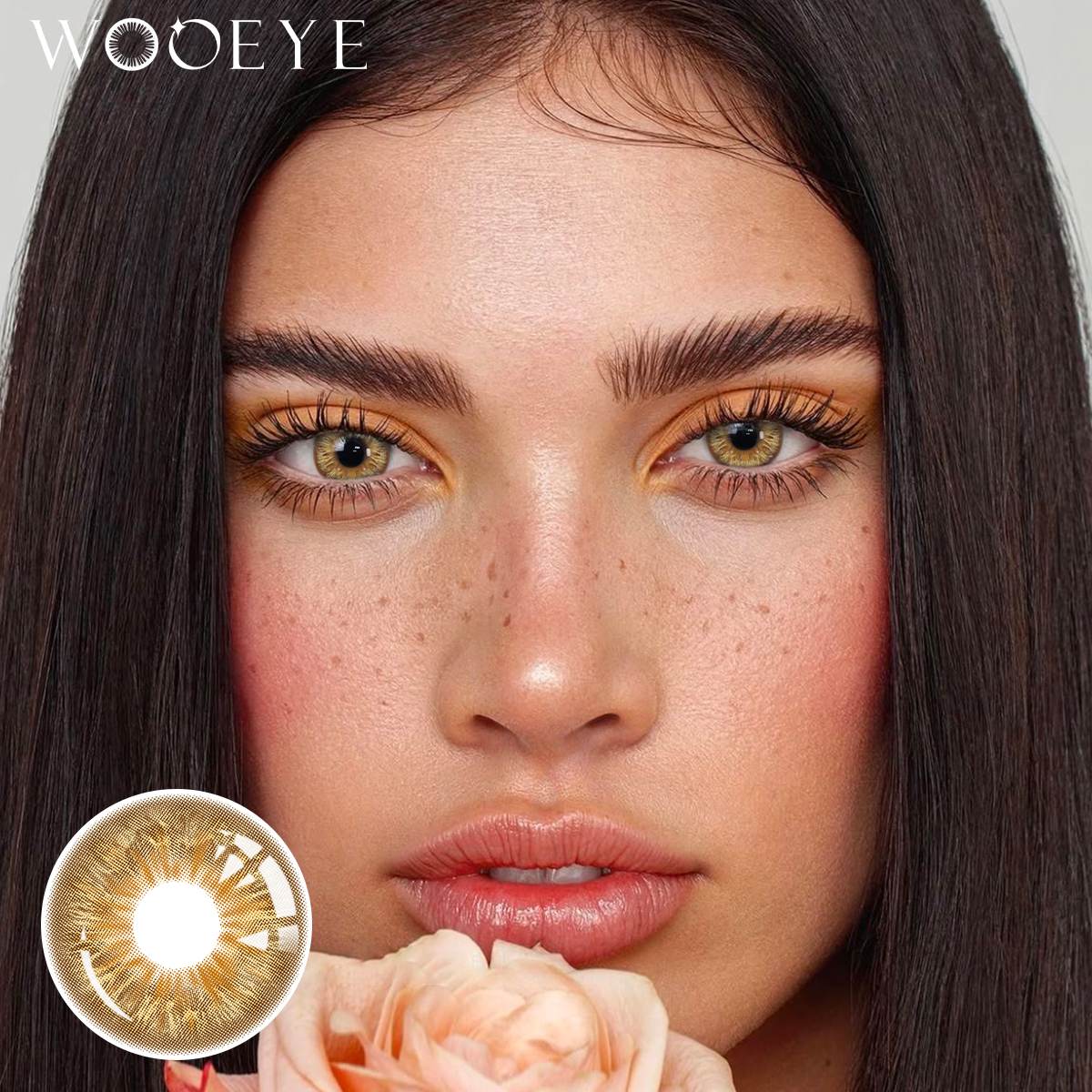 The girl's face is looking straight ahead, the upper left is the Wooeye logo, and the lower left is a close-up of the Vegas Brown contact lens
