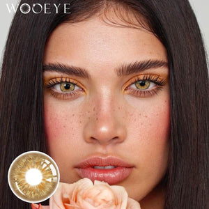 The girl's face is looking straight ahead, the upper left is the Wooeye logo, and the lower left is a close-up of the Vegas Brown contact lens