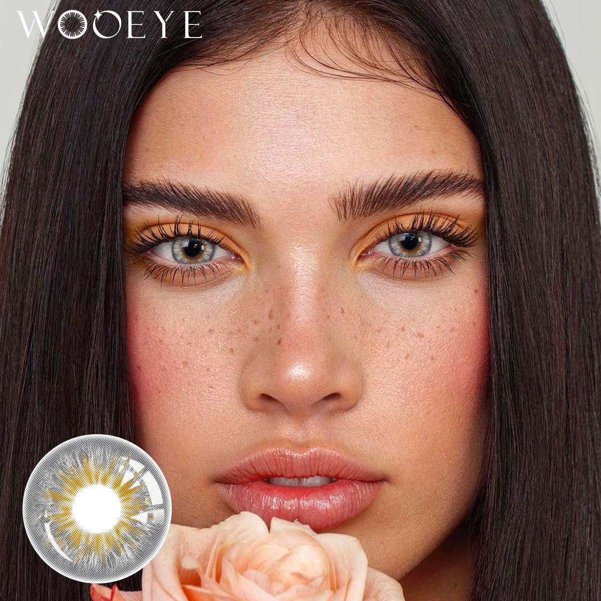 The girl's face is looking straight ahead, the upper left is the Wooeye logo, and the lower left is a close-up of the Vegas Grey contact lens