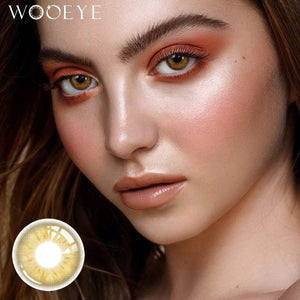 The girl's face is looking straight ahead, the upper left is the Wooeye logo, and the lower left is a close-up of the Coral Brown contact lens