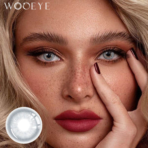 The girl's face is looking straight ahead, the upper left is the Wooeye logo, and the lower left is a close-up of the Cape Cod Blue contact lens