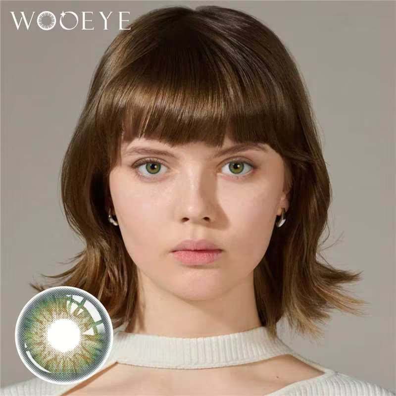 The girl's face is looking straight ahead, the upper left is the Wooeye logo, and the lower left is a close-up of the dancer deep green contact lens
