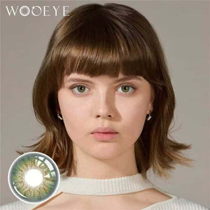 The girl's face is looking straight ahead, the upper left is the Wooeye logo, and the lower left is a close-up of the dancer deep green contact lens